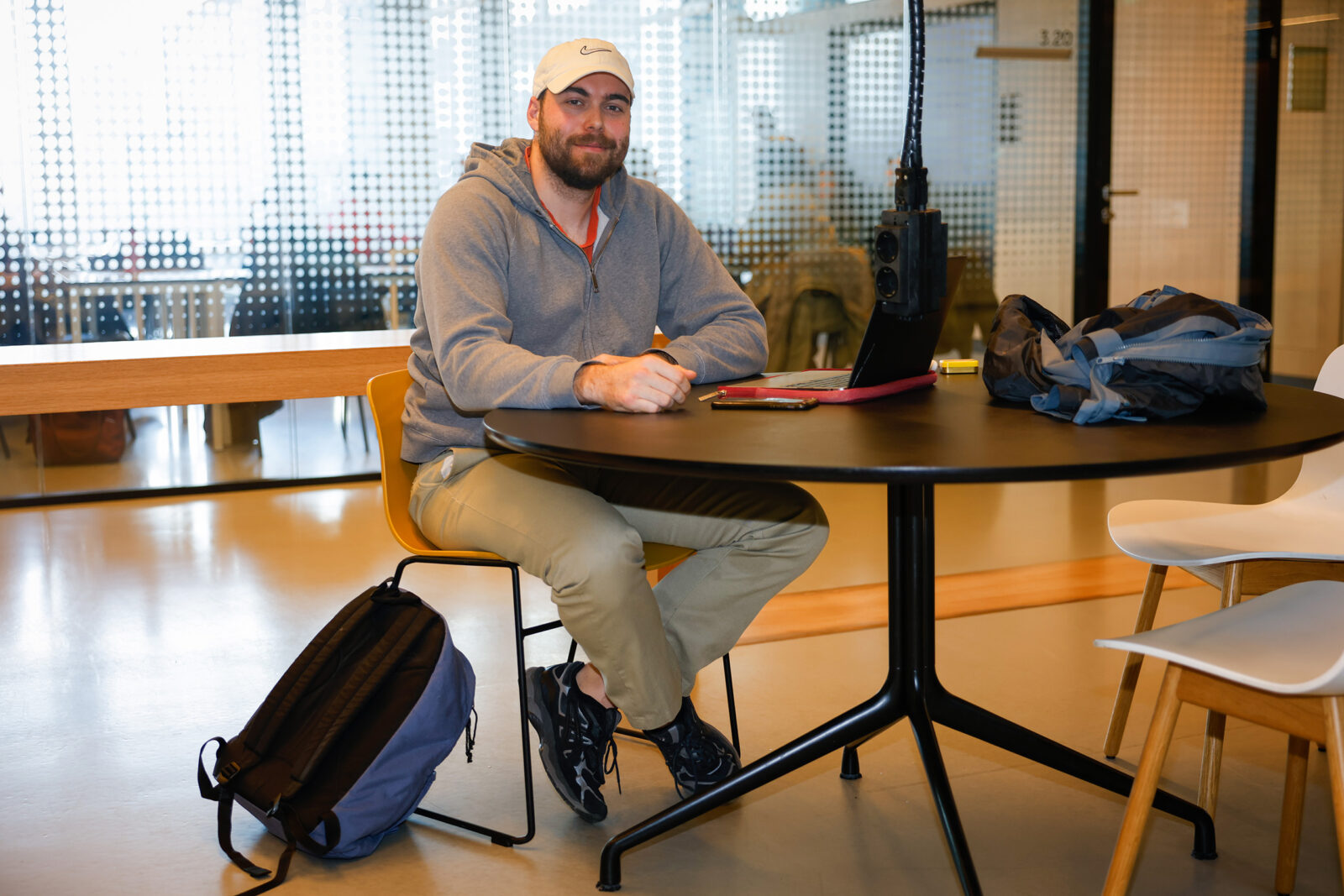 Student Simon is sitting at the table studying