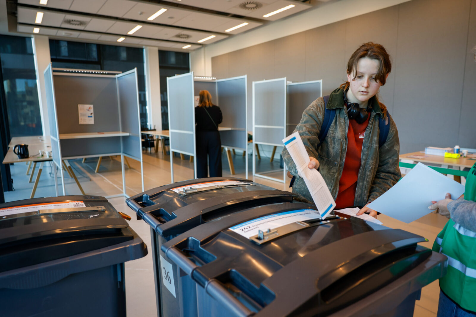 Camilla puts the voting ballot in the right container