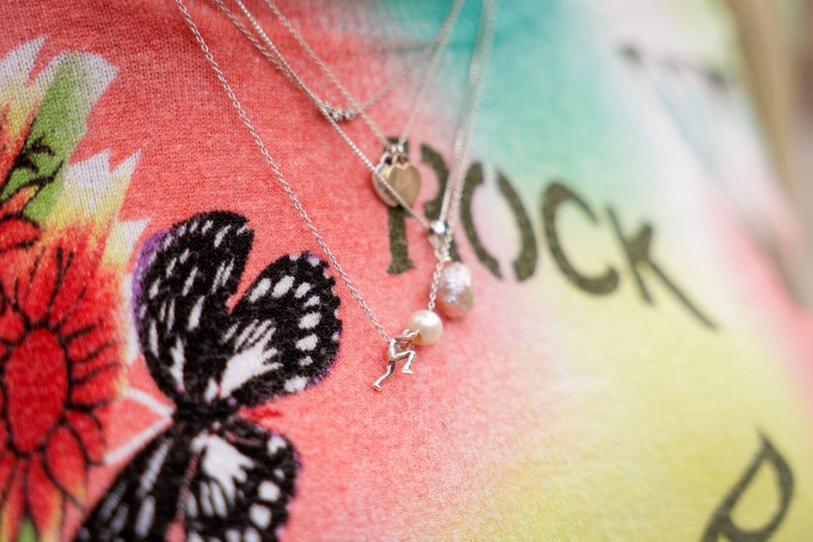 Aan de ketting van Benita duwt een klein zilveren mannetje een parel voort