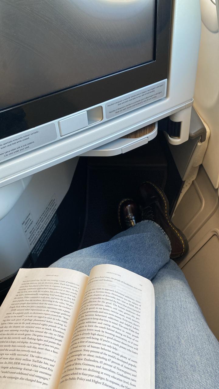 While waiting in the aircraft for an hour, Helena killed time by reading.